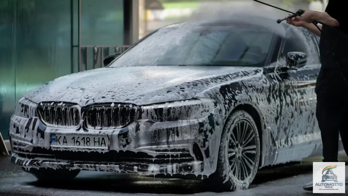 Black BMW covered in foam during a car wash
